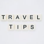 light sign that says Travel Tips